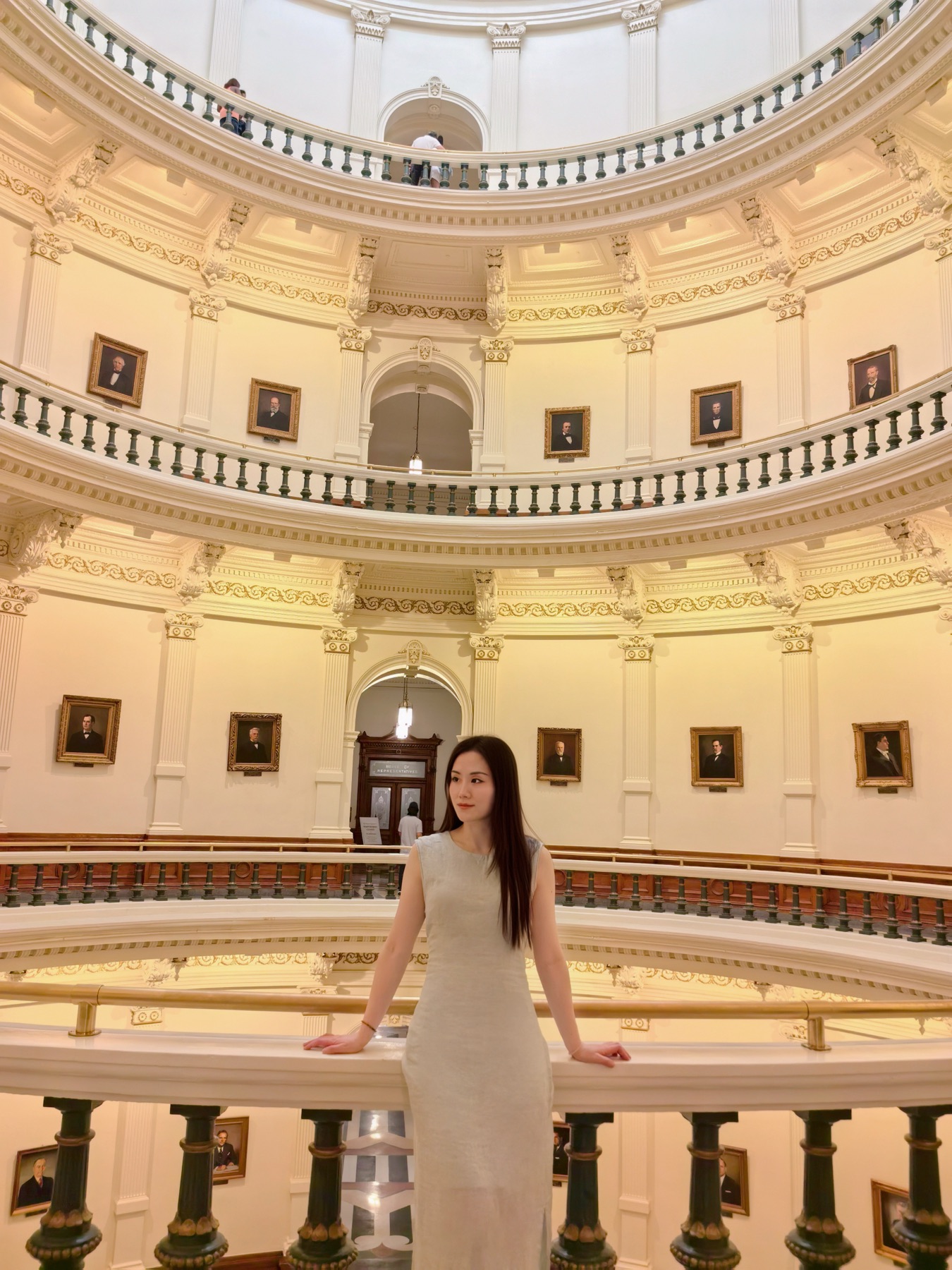 Kaia Guan standing at a curved balcony and looking toward the portfolio introduction